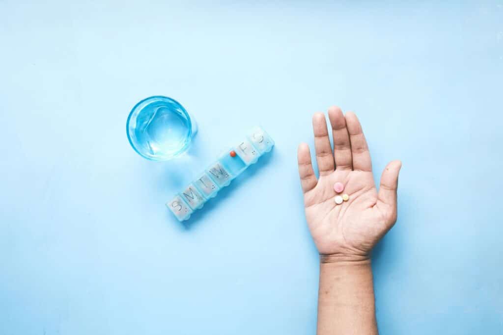 Hand holding pills, symbolizing mental health medication management at Ventana Mental Health