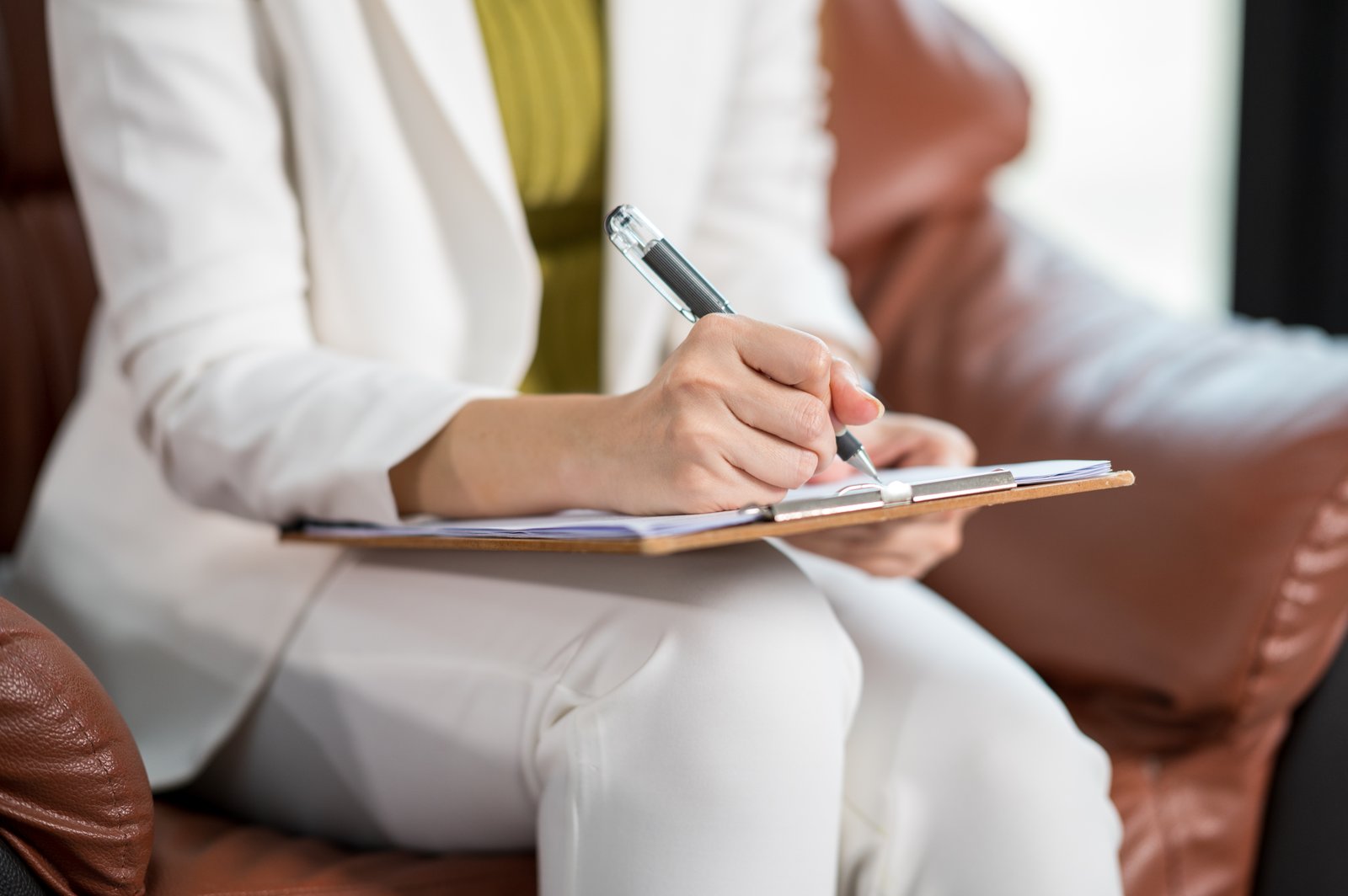 Illustrative stock photo: Representative clinician taking notes during a consultation